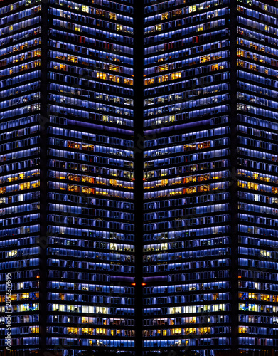 Multi-stories office building at night with worker working overtime. late night at office. lighting and working people within