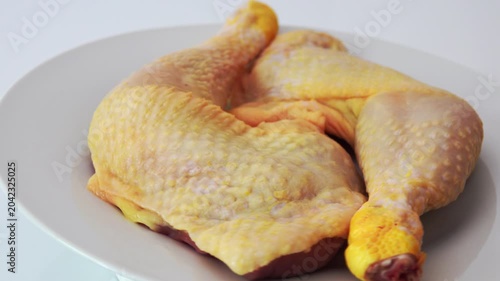 Raw chicken pieces on a plate