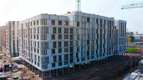 Construction site update on residential development with tower cranes and new building structures in urban area