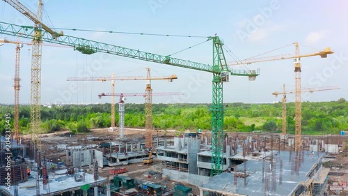 Construction site overview of tower cranes and residential development in an active urban construction zone