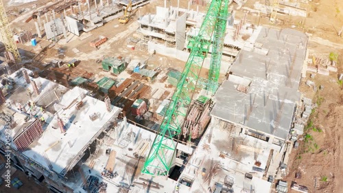 Construction progress at residential development site featuring tower cranes and active machinery for urban expansion