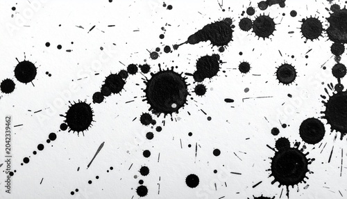 Abstract Black Ink Splatters and Blobs on White Paper Background