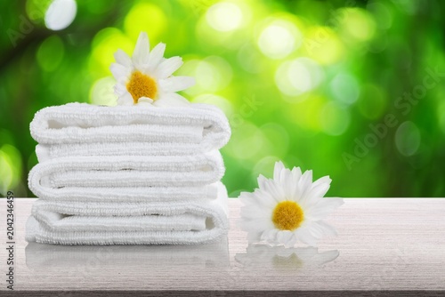 Fresh clean Towels and Daisies flowers
