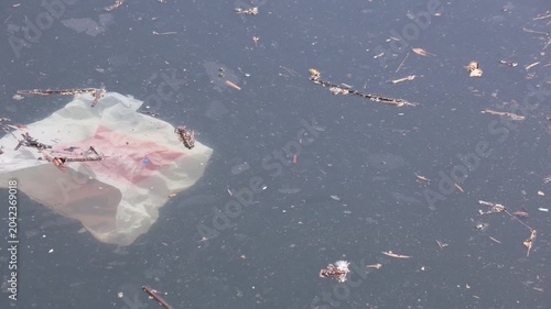 Plastic Bag With Debris Floating In Water