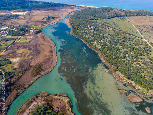 Bild auf Leinwand Aerial view of a meandering river flowing through diverse landscapes