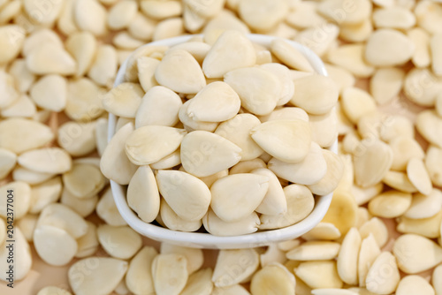 Konstfotografi Blanched Sliced Almonds in White Spoon - Healthy Nuts Ingredient Background