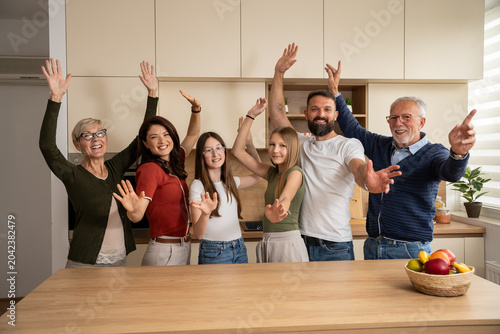Fotografie Multigeneration family smiling and waving together with happiness