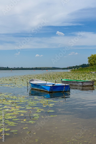 A peaceful walk unfolds along the Ternopil Pond in Ternopil, Ukraine, where calm waters and lush surroundings create a serene urban retreat.
