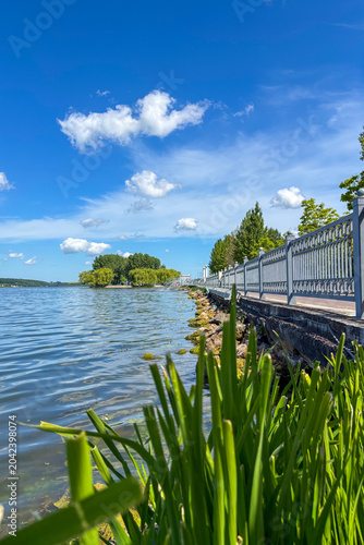 A peaceful walk unfolds along the Ternopil Pond in Ternopil, Ukraine, where calm waters and lush surroundings create a serene urban retreat.
