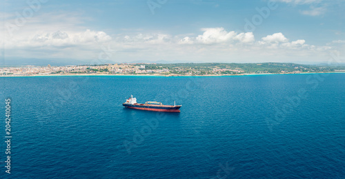Bild auf Leinwand Cargo ship anchored in Mediterranean Sea near Tarragona coastline Spain