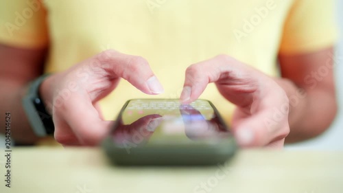 A close-up shot of a person's hands texting and typing on a smartphone screen, ideal for mobile technology and communication concepts.