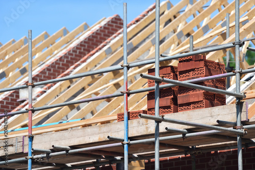 Tablou pe pânză New housing building work on roof beams and brick work of property