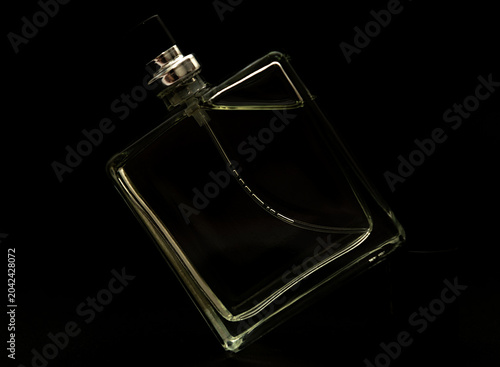 Classic men's cologne on a black background. Top view.
