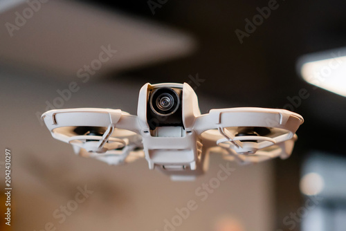 Vászonkép Macro shot of standalone lightweight camera drone flying inside a modern office