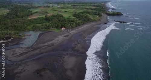Exploring the black sand beaches and green hills of Bali through drone footage