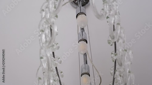 Modern glass chandelier illuminating a bright interior space