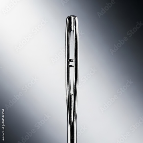 Macro view highlighting the dangerously sharp point of a metallic sewing needle or pushpin, emphasizing precision and potential danger, attack, tip, security