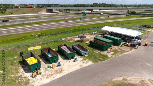 Aerial view of recycling dumpsters with sorted waste

