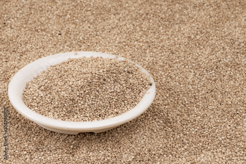 Chenopodium quinoa - Organic white quinoa seeds in bowl and spoon