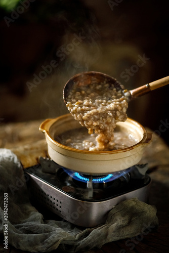 Принти на полотні Steaming Red Bean Porridge in Ceramic Pot Over Gas Flame