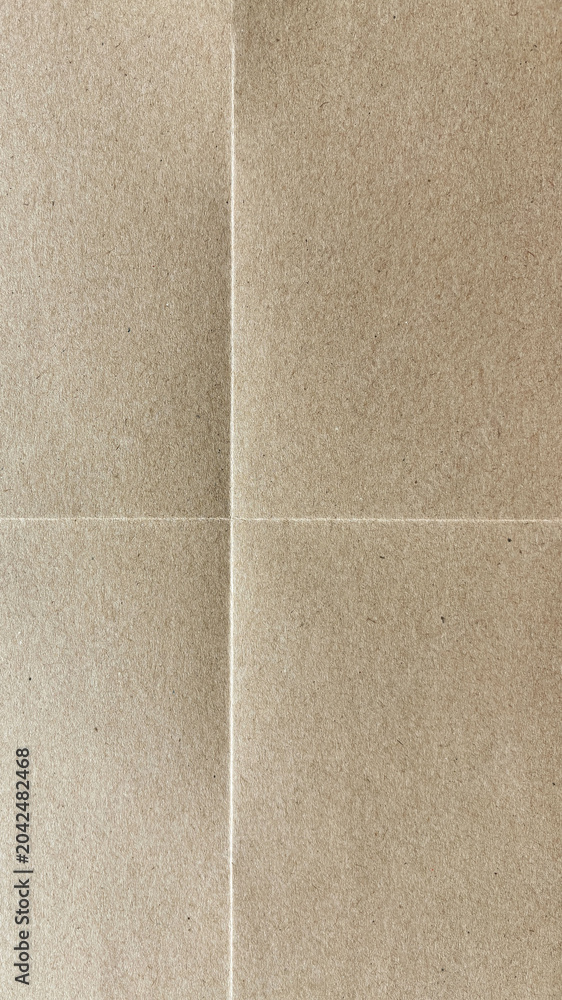 Fototapeta premium Close-up of a textured, folded brown paper surface with visible creases.