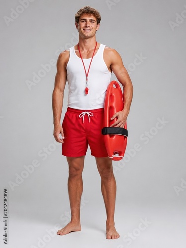Lifeguard Holding Rescue Float And Whistle