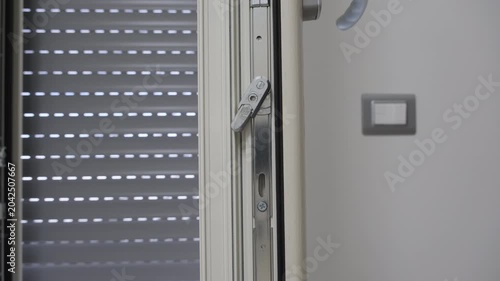 Window handle and shutter mechanism detail.