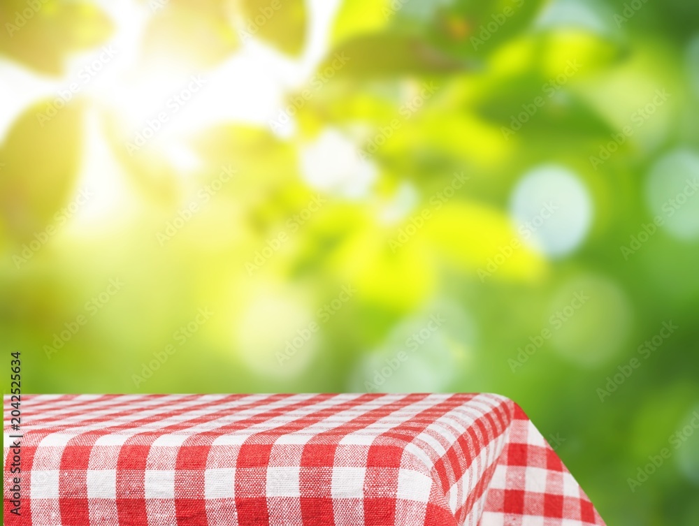 Obraz premium Fabric tablecloth on wooden table on blur background