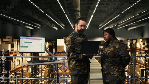 Bild auf Leinwand Armed forces diverse personnel working in military warehouse and managing cargo for defense, inspection for inventory, Soldiers ensuring command and control systems in military base