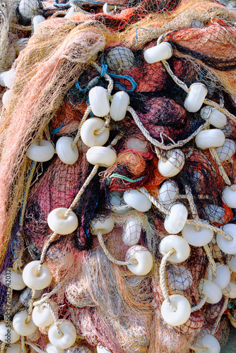 Fishing net floats and colorful marine ropes. Nautical texture background.