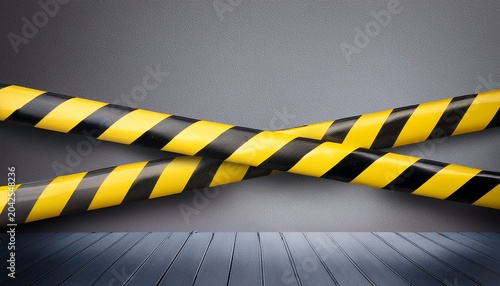 warning tape barricade fencing with black and yellow stripes in gray background