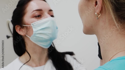 A female doctor, a professional cosmetologist, and a client are very happy after a procedure at a cosmetology clinic