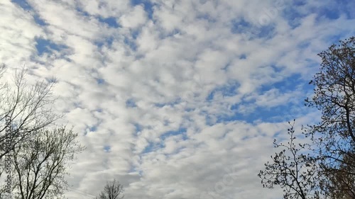 Open sky filled with drifting clouds and soft gradients in bright daylight.