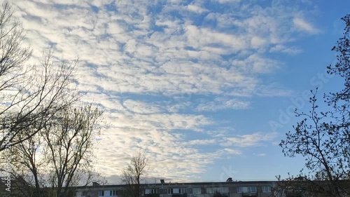 Calm cloudscape with bright daylight and airy white clouds drifting across the sky.