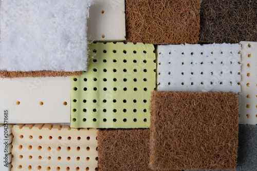 Tableau sur toile Close-up of stacked mattress material samples, including firm coconut coir layers and soft latex foam