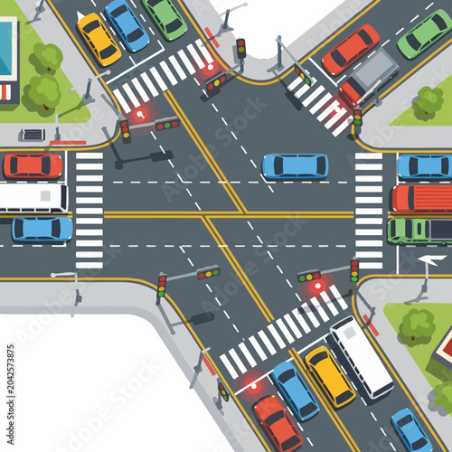 An overhead view of a busy city intersection with cars, crosswalks and traffic lights in operation