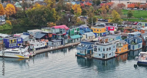Aerial view of colorful floating houses under a cloudy sky in Victoria Harbour, Canada