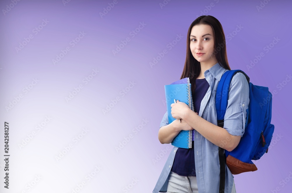 Fototapeta premium Happy young school student standing on background