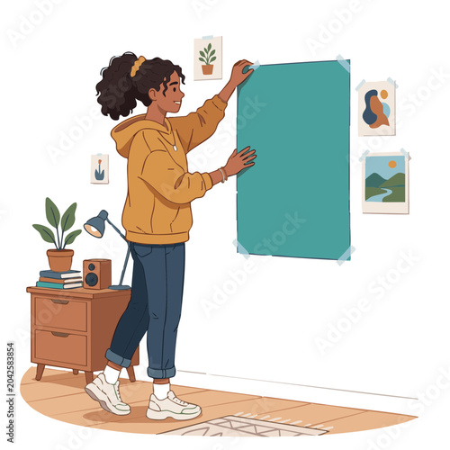 Young black woman putting up a poster in a cozy room  