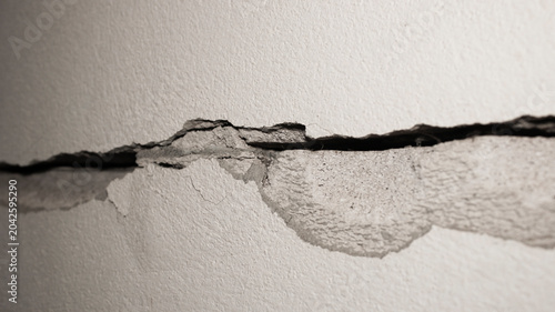 Detailed Close-Up of Cracked and Peeling Wall Surface Texture