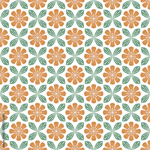 A seamless vector pattern featuring stylized orange geometric flowers and green leaves arranged in a symmetrical grid. 
