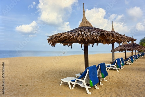 Parasols and beach chairs on th beach at Kho Ko Khao, Phang Nga,