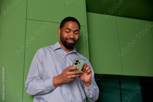 Businessman looks at his phone