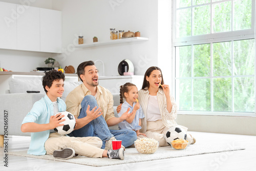 Happy family with snacks an...
