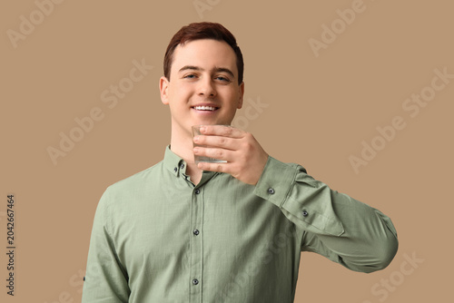 Handsome young man drinking...