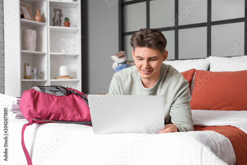 Male tourist using laptop o...