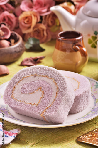 Slice of taro swiss roll on the plate   