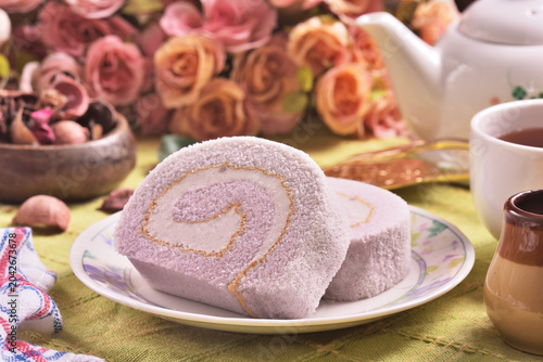 Slice of taro swiss roll on the plate   