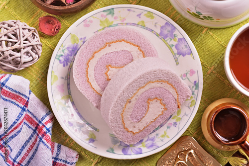 Slice of taro swiss roll on the plate   