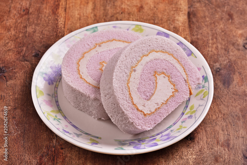 Slice of taro swiss roll on the plate   